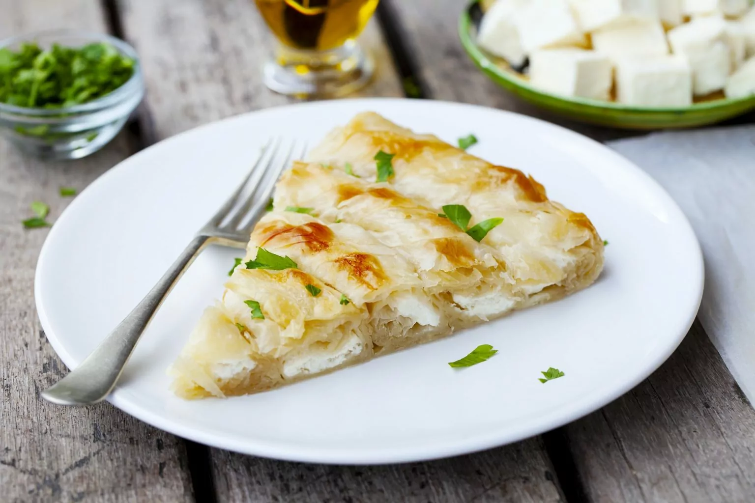 Traditional Feta Cheese Phyllo Pastry Pie, Banitsa. Wooden Background. Close up.