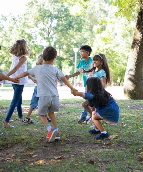 happy-children-playing-together-outdoors-dancing-around-grass-enjoying-outdoor-activities-having-fun-park-kids-party-friendship-concept